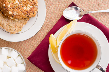 Breakfast with pastries, and hot tea with lemon.