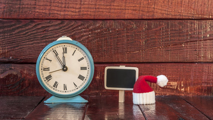 vintage alarm clock and christmas decoration on wooden backgroun