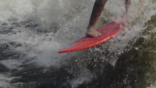 Extreme Sports Athlete doing tricks on board behind boat