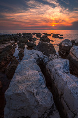 Sunset Over the Sea with Rocks in Foreground