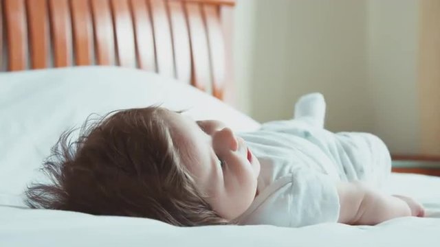 Newborn baby lying on the bed