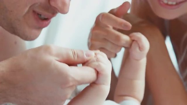 Newborn child and happy faces mother and father