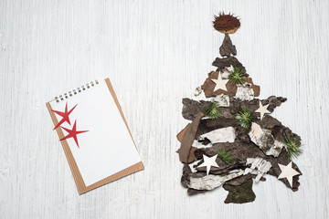 Christmas tree made of tree bark on retro background with space for text
