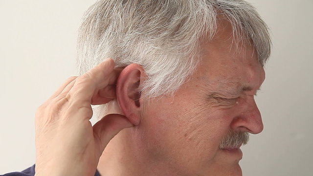 senior man suffering from pain in and around his ear