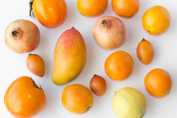 Many fresh orange fruits on white background -