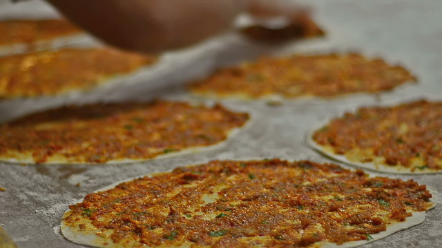 Prepearing Turkish pizza called Lahmacun