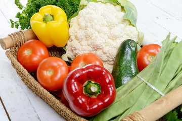 basket of seasonal vegetables on white wooden table