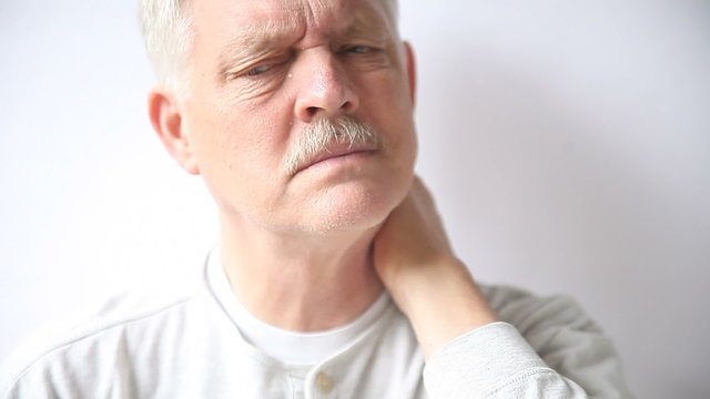 An older man suffers from pain in his neck.
