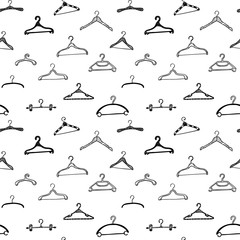 Fashion modern seamless pattern with doodle clothes hangers. Vector background.