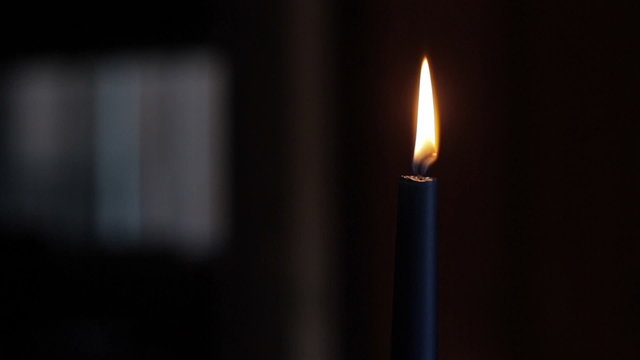 moving finger through candle flame closeup