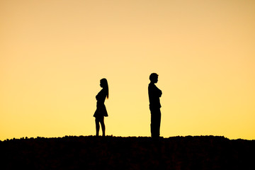 Fototapeta na wymiar Silhouette of a angry woman and man on each other / Relationship difficulties / Couple break up