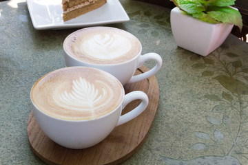 Obraz na płótnie Canvas Close up cup of Coffee latte on the wood table