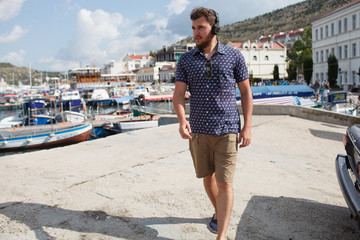 Male tourist in small summer town by the seaside