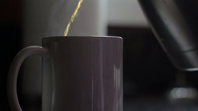Closeup of a white mug of hot coffee