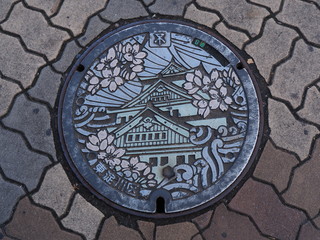 Manhole drain cover on the street at Osaka, Japan. 