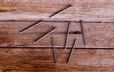 nails put on brown wooden plank