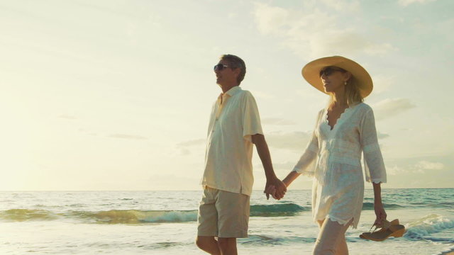 Sunset Walk on a Tropical Beach. Happy Retired Couple on Tropical Vacation.
