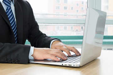 Businessman using laptop at work