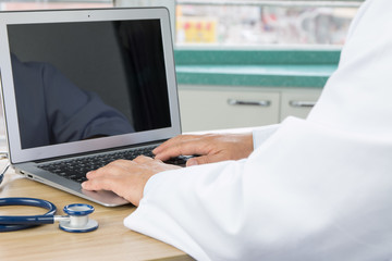 Doctors using laptop at work