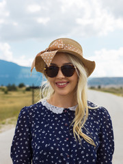 young woman walking on a long deserted road