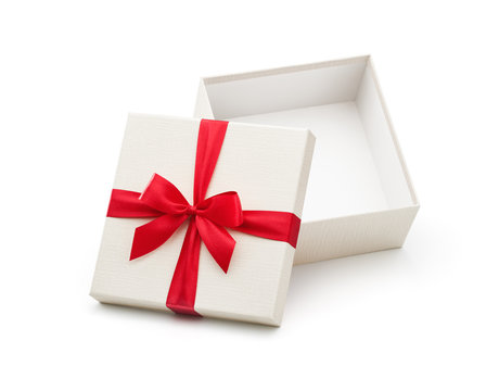 White open gift box with red bow isolated on white background - Clipping path included