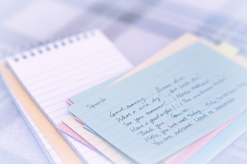 Obraz premium Spanish; Learning New Language Writing Greetings on the Notebook