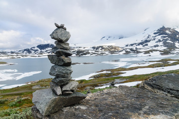 Balanced stack of stones against snowy mountains