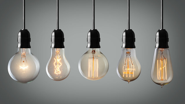 Vintage hanging light bulbs over gray background