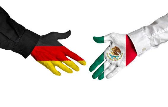 Germany and Mexico leaders shaking hands on a deal agreement