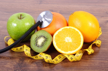Stethoscope, fresh fruits and centimeter, healthy lifestyles and nutrition