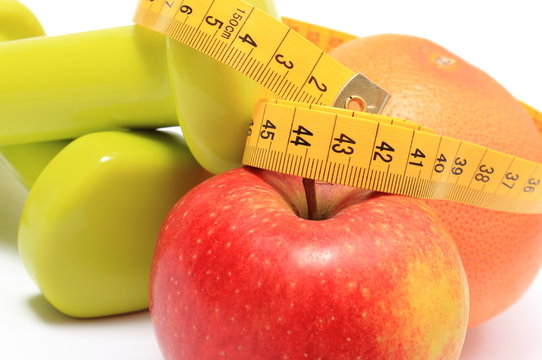 Fruits, tape measure and green dumbbells