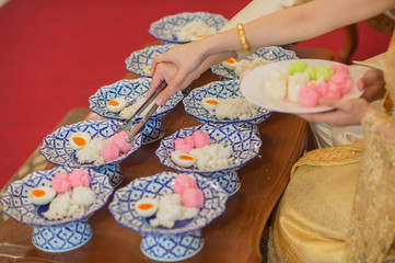 bride and groom give alms food to monk in tradition wedding ceremony Thailand