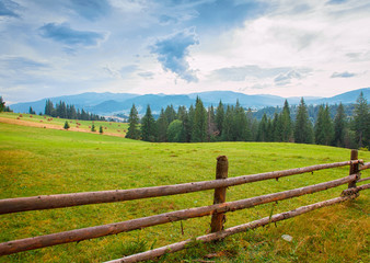 Fototapeta na wymiar wooden fence mountain landscape