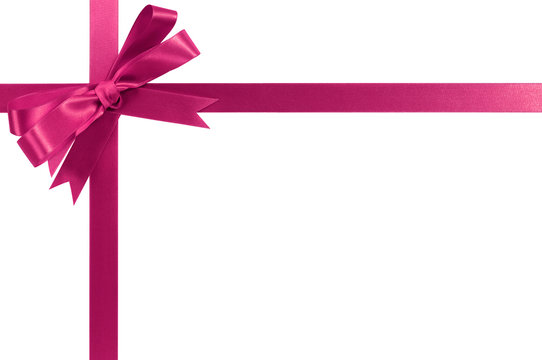 Pink gift ribbon bow horizontal corner cross shape isolated on white for christmas or birthday present design decoration photo