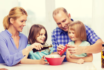 Obraz na płótnie Canvas happy family with two kids making dinner at home