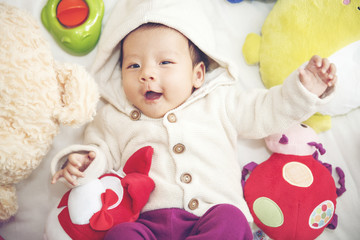 Baby with toy and doll