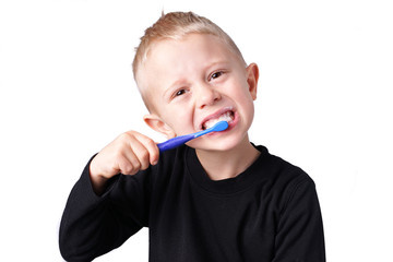 Boy brushes his teeth