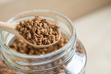 Instant coffee in a spoon, closed up.