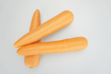 Stack of fresh orange carrots on white background