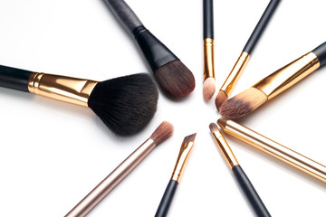 Fototapeta premium Top view of Brush and cosmetic on white
