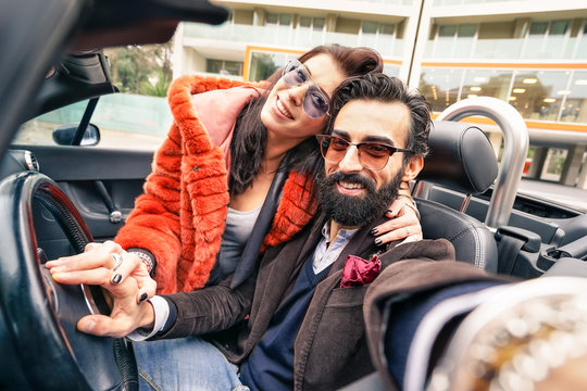 Handsome hipster boyfriend having fun with girlfriend - Happy couple taking selfie at car trip - Modern love relationship concept with people traveling together - Main focus on face of the guy