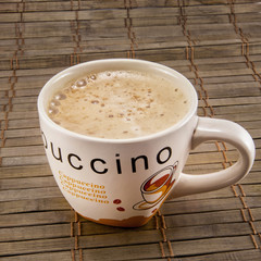Cup full of coffee beans isolated
