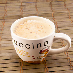 Cup full of coffee beans isolated