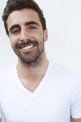 Portrait of smiling young man in white