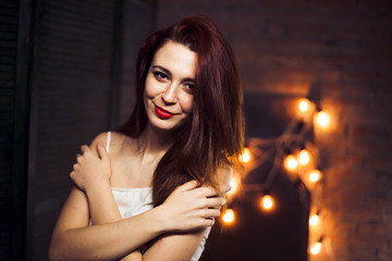 The girl with red hair against the background lights