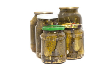 Pickled cucumbers in jars isolated on white