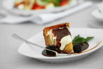 Delicious cake under chocolate glaze with blackberry