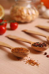 Variety of spices in spoons on the kitchen table
