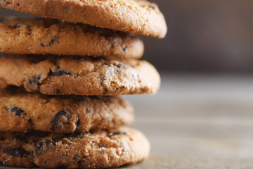 Cookies with chocolate crumbs on wooden table, close up