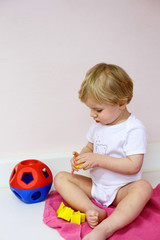 Little toddler boy playing with  puzzle toys